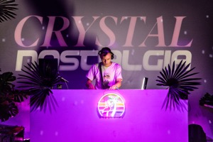 AHBL djing and standing in front of the crystal nostalgia wall light logo