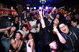 A nightclub photo of a full crowd posing for a shot during Sailor Rave at Lion's Den in San Francisco