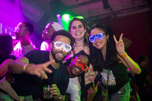 A nightclub portrait of a group of cool people in light-up shutter glasses on stage at Yoi Toki San Francisco